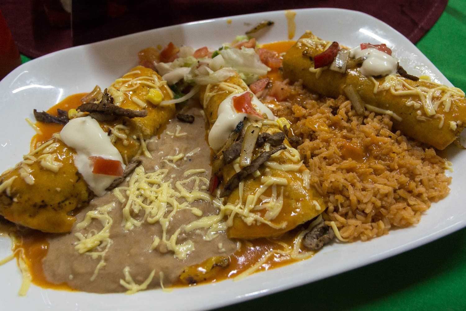 Enchiladas de fajitas, filled with the same ingredients you'd find in fajitas: beef, onions and bell peppers. Found at Hot Rod Burrito Grill.