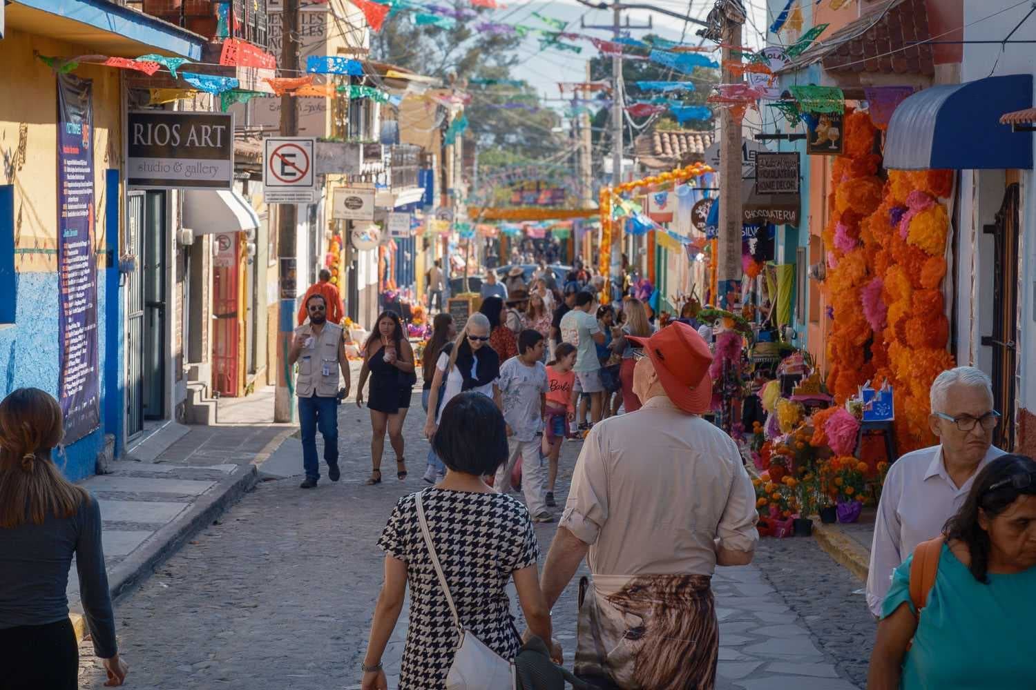 Visitors stroll the main street in Ajijic mid-afternoon on the Day of the Dead.