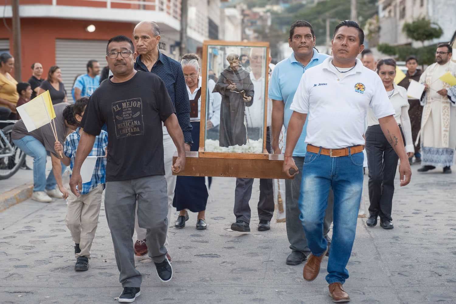 Sponsors of the day's fiestas carry an image of Saint Francis during one of the evening processions.